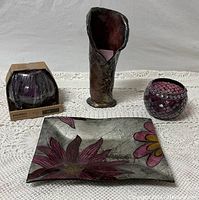 Full view of all four items including the purple pottery vase, flower tray, candle holder, and boxed light