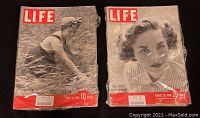 Two LIFE magazines, one with woman in field cover, the other with woman's portrait cover, both in plastic sleeves