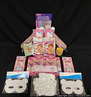 Craft and doodling items including Fancy Nancy Play Packs, Hello Kitty Journals, coloring masks, crayons, and assorted craft packs.