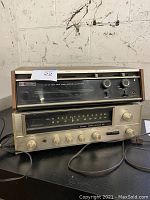 Both vintage stereo receivers stacked: Hitachi KS-2210 on top, Sansui 221 below, showing front panels and condition.