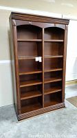 Front view showing overall design, wood finish and shelf configuration