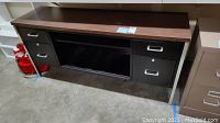 Metal credenza front view showing four metal drawers with silver handles and central open compartment