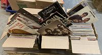 Three cardboard boxes filled with vinyl LP records, front view