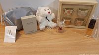 Full lot overview with perfumes, plush bear, and candle holders