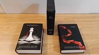 Full view of the three hardcover Twilight Saga books: Breaking Dawn, Eclipse, New Moon. New Moon is in a slipcase.
