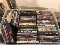 Photo of stacked DVD cases showing various drama movie titles such as Donnie Darko, Fracture, Snatch, and Inception.