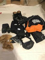 Full lot of Harley Davidson men's rainwear, boots, gloves, belt pack, and gaiters laid out flat on light fabric.