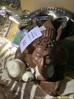 Front view of wood Lord Ganesh sculpture with carved details