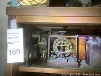 Vintage induction coil device on shelf with two metal canisters