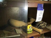 Shelf view showing wooden sculptures, cat jewelry box and other lot items behind glass