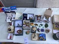 Overview of lot on table including porcelain and enamel boxes, jade carvings, wooden giraffes