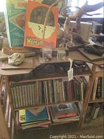 Full view of wooden shelf showing top surface with games, sculptures and cubes