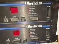 Front view of two stacked Oberheim units showing brand logo, function LEDs, navigation buttons and volume slider.