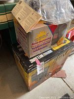 Image of boxed Auto-Darkening Welding Helmet on top of the welder box, showing packaging condition