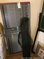 Mixer leaning against wall with black bag in front