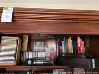Shelf with assorted audio CDs and partial view of DVD box sets