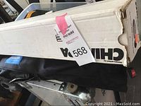 Cardboard box labeled Chimera alongside black carry bag with MaxSold tag