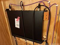 Black rack-mount style sound board strapped to plywood with Velcro, two purple cables connected to top, label “321” affixed.