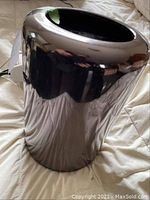 Front perspective of cylindrical Mac Pro showing exterior finish and top opening