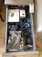Drawer of assorted camera bodies, adapters, caps and accessories