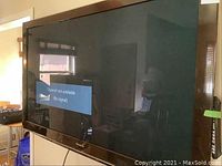 Front view of Panasonic 58 inch TV mounted on wall showing screen displaying 'Channel not available (No signal)'.