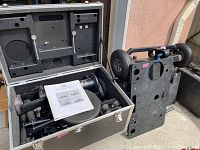 Open flight case showing folded dolly components and seat