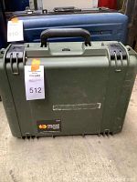 Green Pelican Storm Case with handle and latch closures in front of a blue case