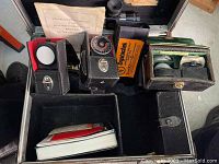 Open case showing collimator, manual, meter, filter disc, Chrystaltek box and lenses