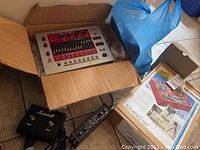 Overview of Roland EF-303 in box, Marshall footswitch, LED meter module, USBPre, and Cullmann tripod box on floor