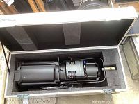 Top-down view of LED lighting fixture seated in foam-lined flight case showing fixture body and yoke