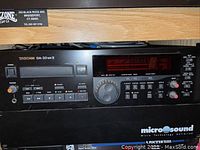 Front view of both rackmount units stacked, showing Tascam logo on top unit and Microsound branding on bottom.