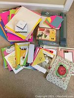 Overview photo showing stacks of colored paper, various cards spread out, and the rotary trimmer underneath.