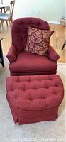 Frontal view of cranberry swivel rocker with matching ottoman