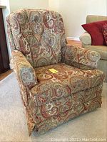 Front view of paisley-pattern swivel rocker chair