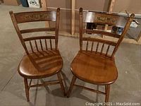 Pair of Hitchcock style wooden chairs shown from above, displaying overall shape, seat, and legs.