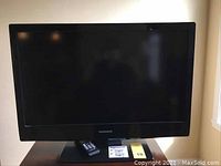 Front view of a black Magnavox television with a 32-inch screen.