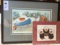Framed Barbara Lavallee"The Big Catch" print and Meribeth Orock seal art print shown together.