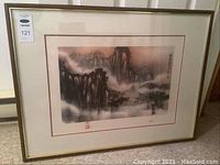 Framed Asian landscape print showing misty mountainous scene with cliffs and pine trees.