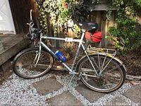 Right side view of the full gray MB-3 21-speed Bridgestone bike featuring the frame, rear rack, saddle bag, water bottle.