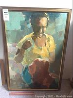 Full view of framed oil painting showing a woman sewing, signed Victor Arcega