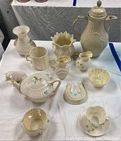 Overall group of 12 porcelain items on white cloth