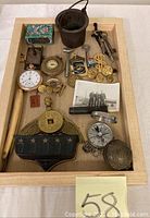 Overview of all lot items arranged in wooden tray