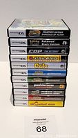 Stack of 11 Nintendo DS game cases, spines visible