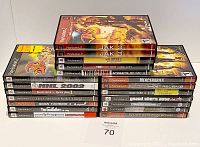 Photo showing stack of 20 video games with visible titles for PlayStation 2 and Xbox games.