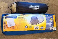 Photo of the Coleman air mattress carry bag and Broadstone Wyndham Tent carry bag with descriptive label