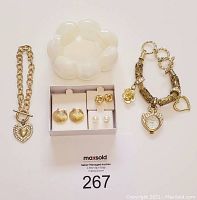 Full lot display showing all bracelets and earrings against a white background with lot number card.