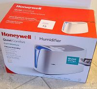 Image of the Honeywell humidifier in its original retail box, showing front and top of the box with product name and image.