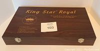 Closed wood case with King Star Royal branding and product details on lid.