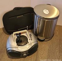 All three items together: laptop tray, stainless steel garbage can, and RCA CD player with antenna extended and power cord