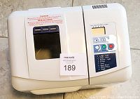 Top view of Regal Pro bread maker showing vent, window lid, caution label, control panel with timer display and program list.